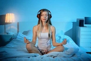 young woman meditating listening music 260nw 6142658542